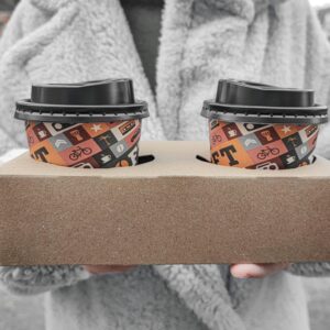 Close-up of hands holding a cardboard tray with decorative coffee cups outdoors.