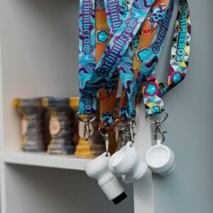 Vibrant lanyards featuring skull designs hang beside shisha bowls in a modern setting.