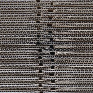 Detailed close-up of corrugated cardboard stack showcasing its wavy texture and pattern.