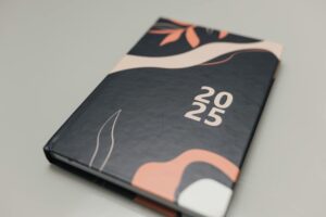 Modern 2025 planner featuring an abstract artistic cover. Perfect for organizing the year.