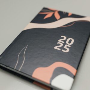 Modern 2025 planner featuring an abstract artistic cover. Perfect for organizing the year.