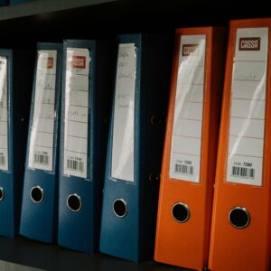 Row of colorful office binders neatly arranged on a shelf, ideal for organization concepts.