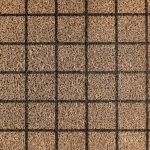 Overhead view of a textured woven coir doormat with a grid pattern.