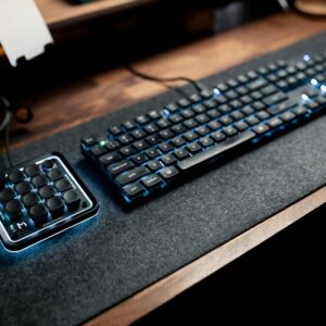 Ergonomic desk setup featuring a mechanical keyboard and macro pad with LED lighting.