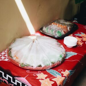 Indonesian street food covered and arranged on a vibrant tablecloth in Bandung.