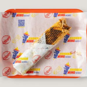 Top view of a grilled wrap on a branded fast food tray, showcasing casual dining.