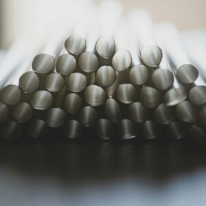 A pile of reusable metal straws stacked neatly, showcasing eco-friendly design.