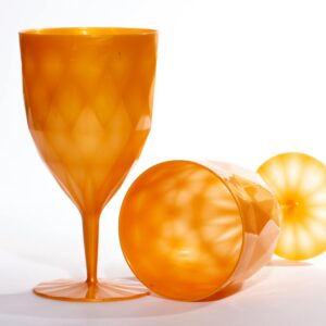 Two orange plastic wine glasses with geometric patterns against a white backdrop, showcasing modern design.