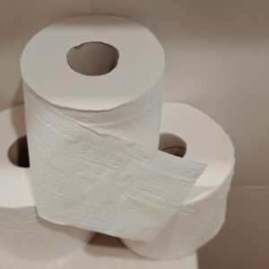 A neatly stacked pile of white toilet paper rolls, ideal for bathroom essentials and hygiene supplies.