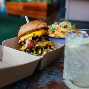 Mouth-watering cheeseburger and refreshing lemonade for a delightful meal.