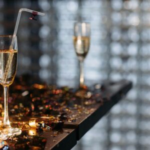 Elegant champagne glasses on a table with festive confetti, creating a celebratory atmosphere.