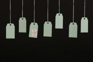 Aesthetic minimalist hanging tags on black background for branding.