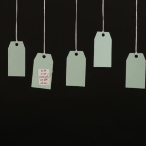 Aesthetic minimalist hanging tags on black background for branding.