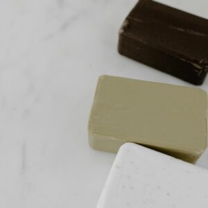 High-angle view of assorted bar soaps on marble, perfect for beauty and cosmetic themes.
