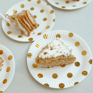 Delicious slices of layered cake on polka dot plates, perfect for a party.