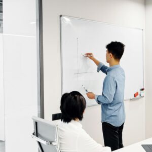 Business professional drawing graph during office presentation with colleague