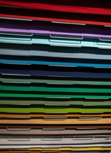 Close-up view of stacked colorful paper files arranged in a pattern.