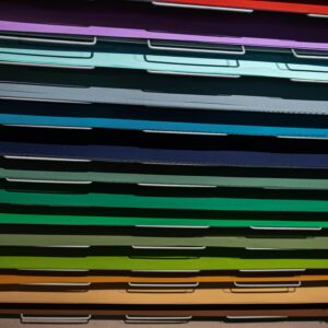 Close-up view of stacked colorful paper files arranged in a pattern.